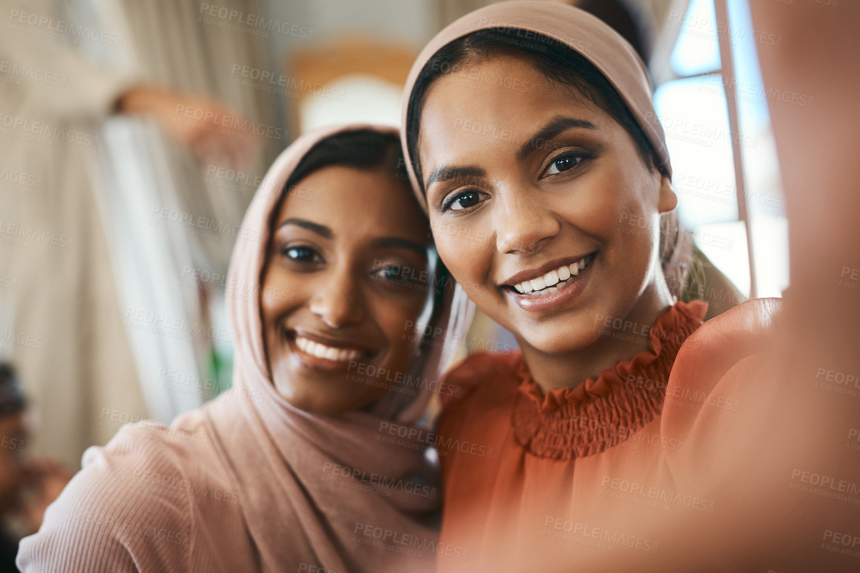 Buy stock photo Shot of two muslim sisters taking selfies together