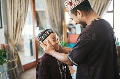 Buy stock photo Shot of a muslim father gazing affectionately at his son