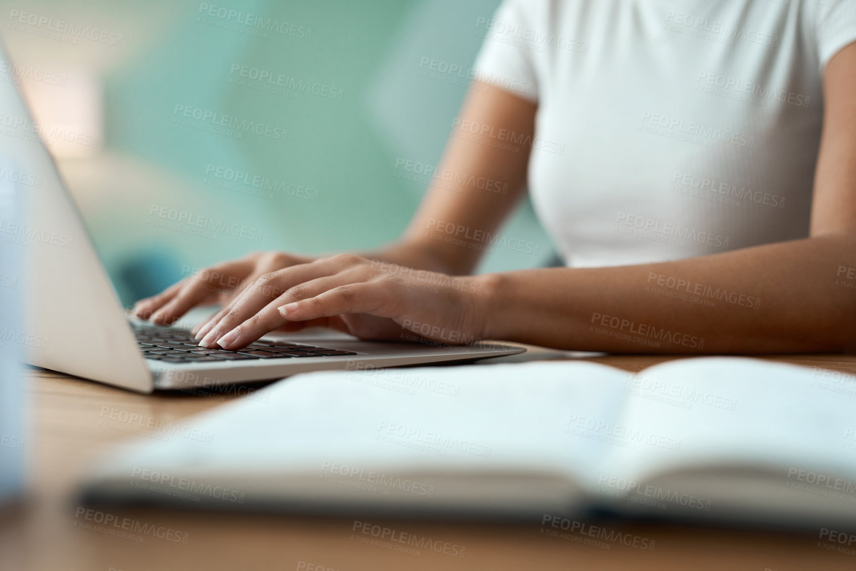 Buy stock photo Shot of an unrecognizable woman using a laptop at home