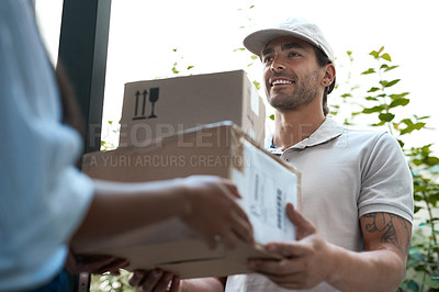 Buy stock photo Shot of a young delivery man making a delivery