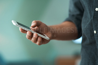 Buy stock photo Shot of an unrecognizable man using a smartphone
