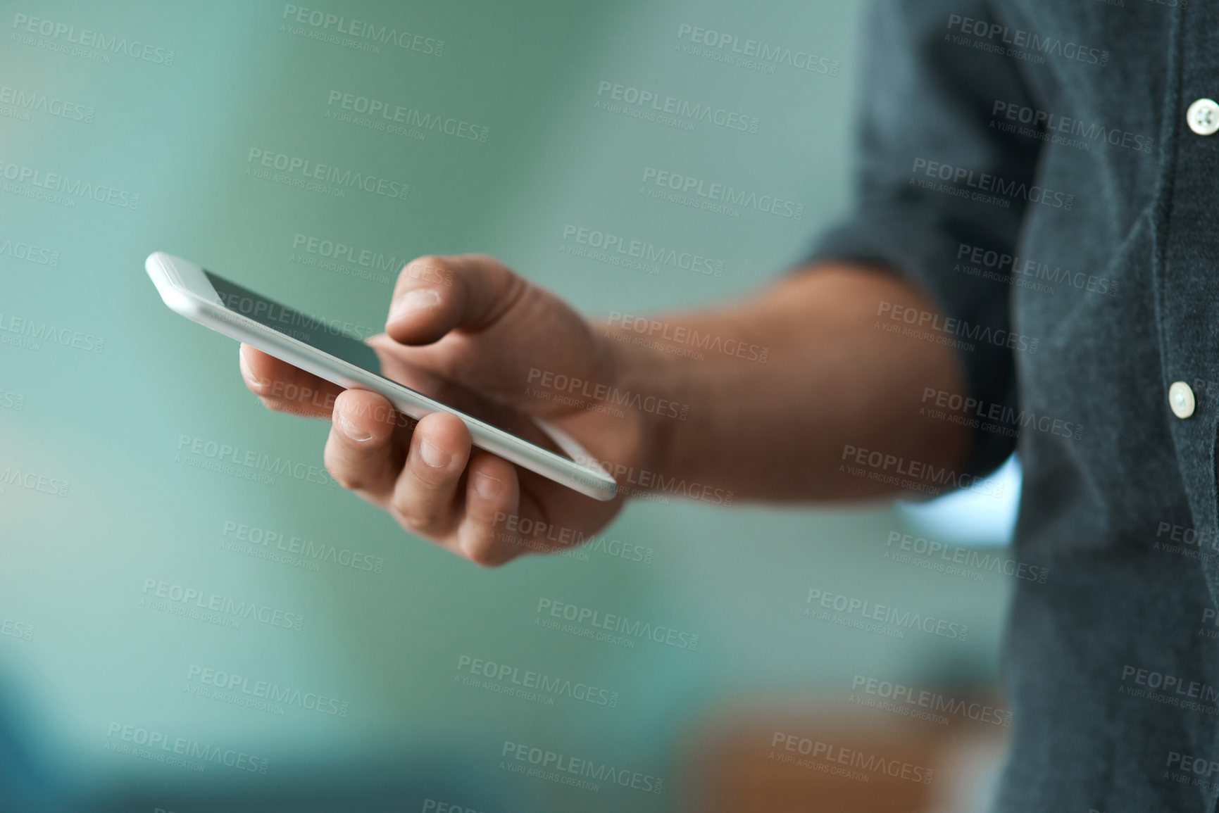 Buy stock photo Shot of an unrecognizable man using a smartphone