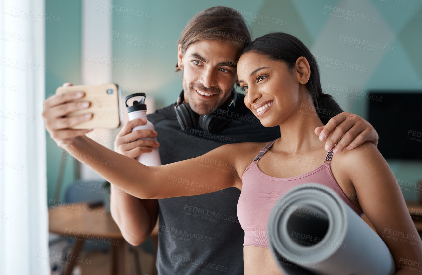 Buy stock photo Cropped shot of an athletic young couple taking selfies before starting their workout at home