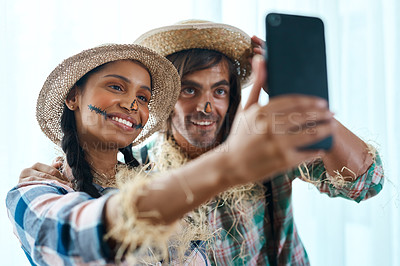 Buy stock photo Shot of a young couple taking a selfie at a party