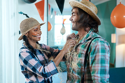 Buy stock photo Shot of a young couple getting dressed for halloween at home