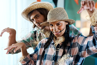 Buy stock photo Shot of a young couple dressed in halloween costumes being being playful at home