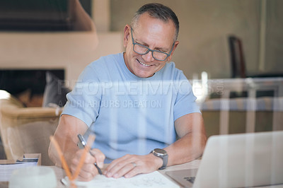 Buy stock photo Shot of a mature man making notes while working