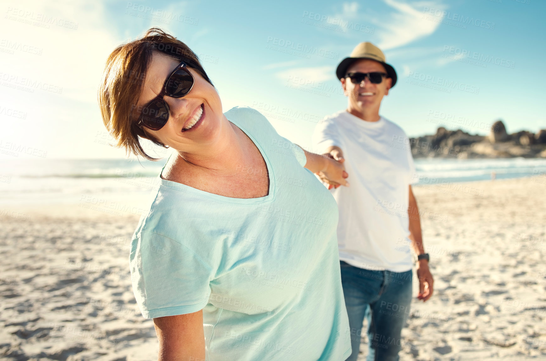 Buy stock photo Shot of a mature couple spending the day at the beach