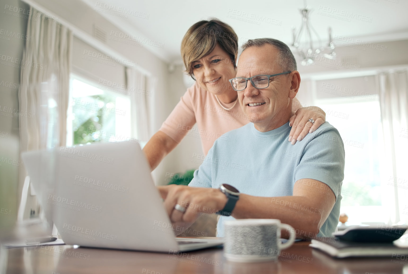 Buy stock photo Shot of a mature husband and wife using a laptop together