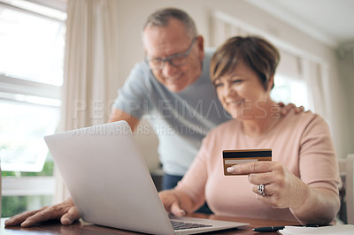Buy stock photo Shot of a mature woman using her card to make online payments