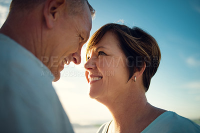 Buy stock photo Closeup shot of an affectionate couple spending the day at the beach