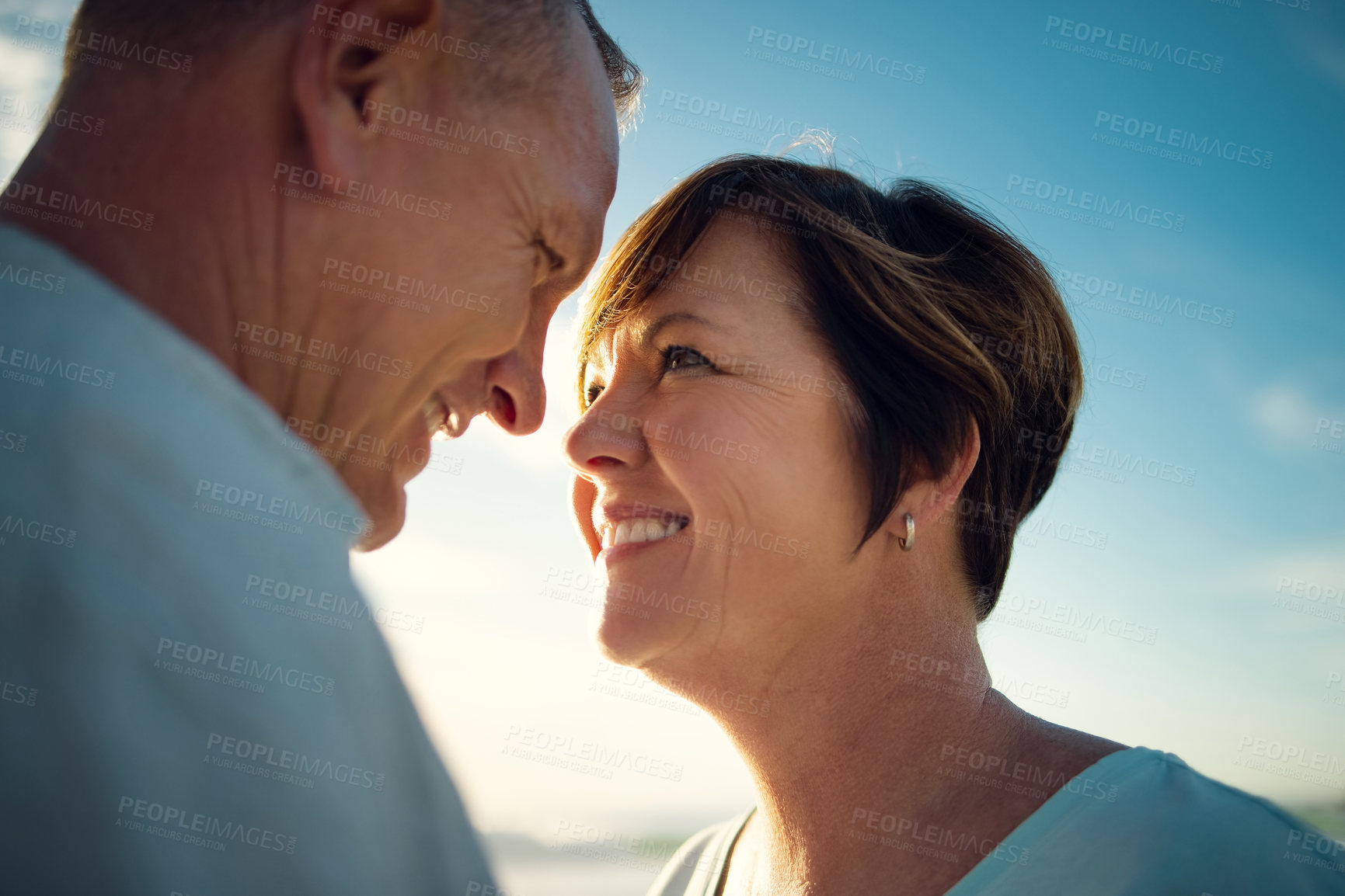 Buy stock photo Closeup shot of an affectionate couple spending the day at the beach