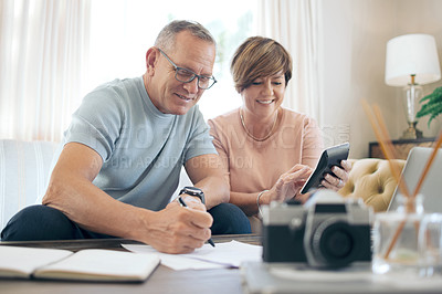 Buy stock photo Shot of a mature couple calculating their budget together