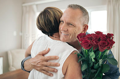 Buy stock photo Shot of a husband giving his wife roses