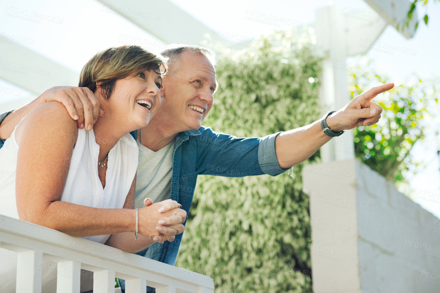 Buy stock photo Shot of a mature couple enjoying the view from their back yard