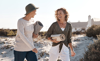 Buy stock photo Cropped shot of two attractive mature woman walking with their on the beach