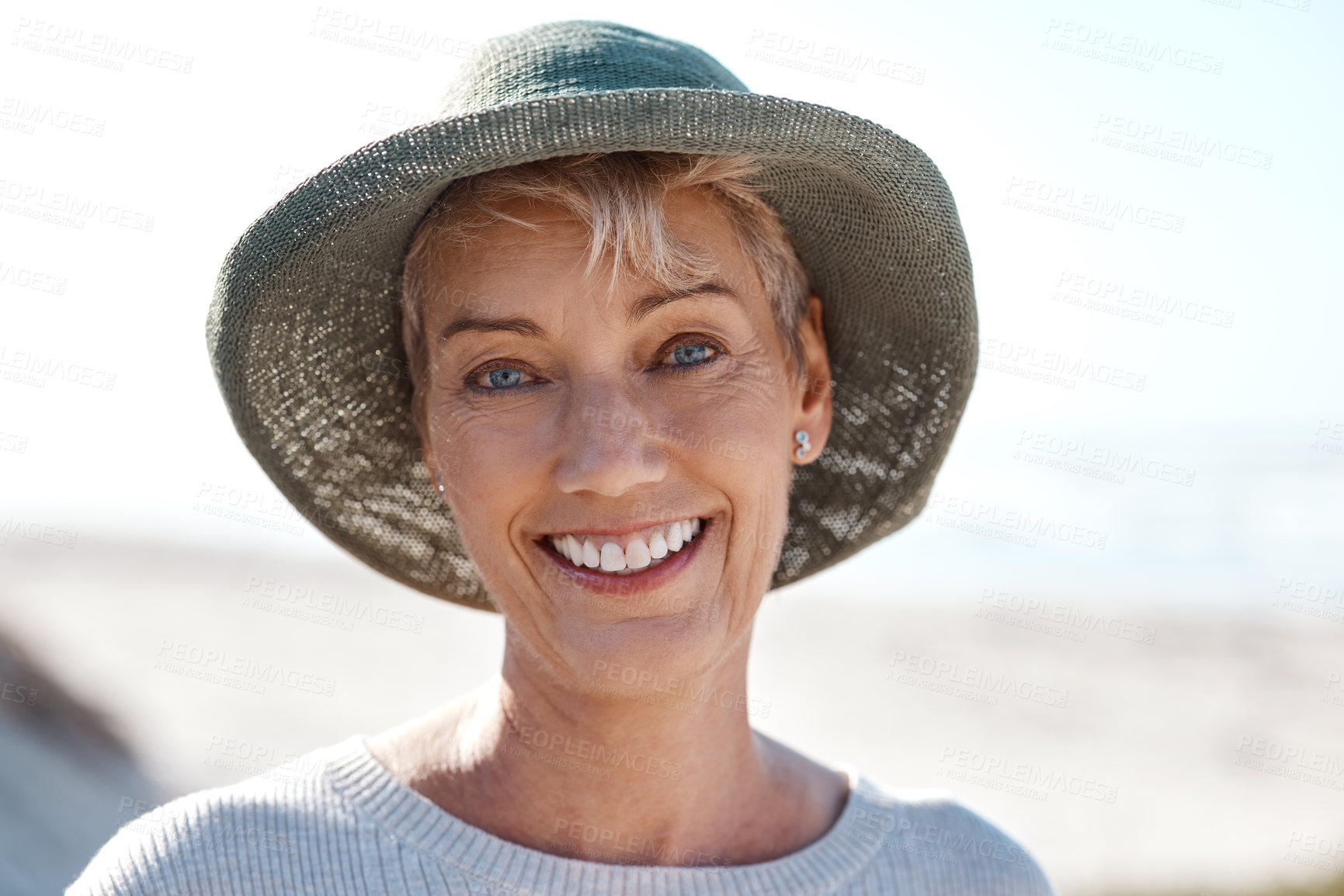 Buy stock photo Cropped portrait of an attractive mature woman standing on the beach