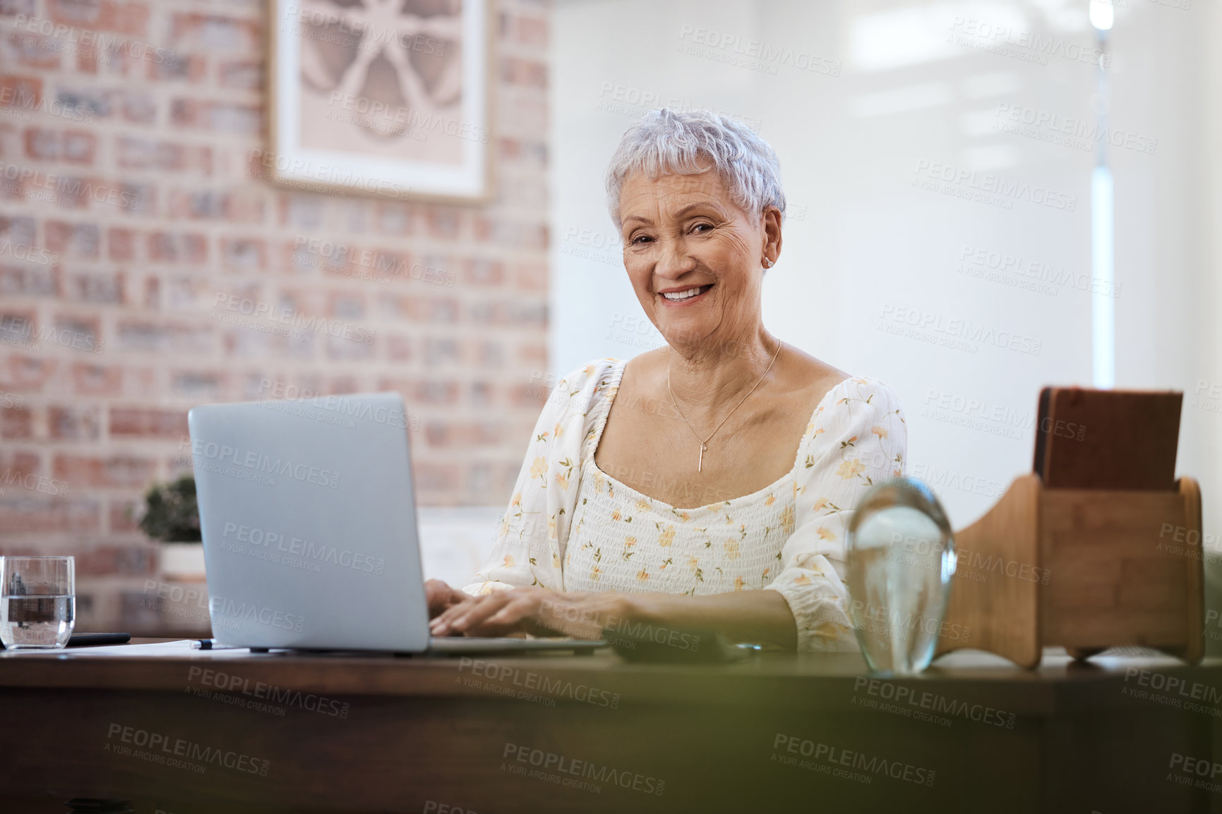 Buy stock photo Shot of a senior woman using a laptop at home