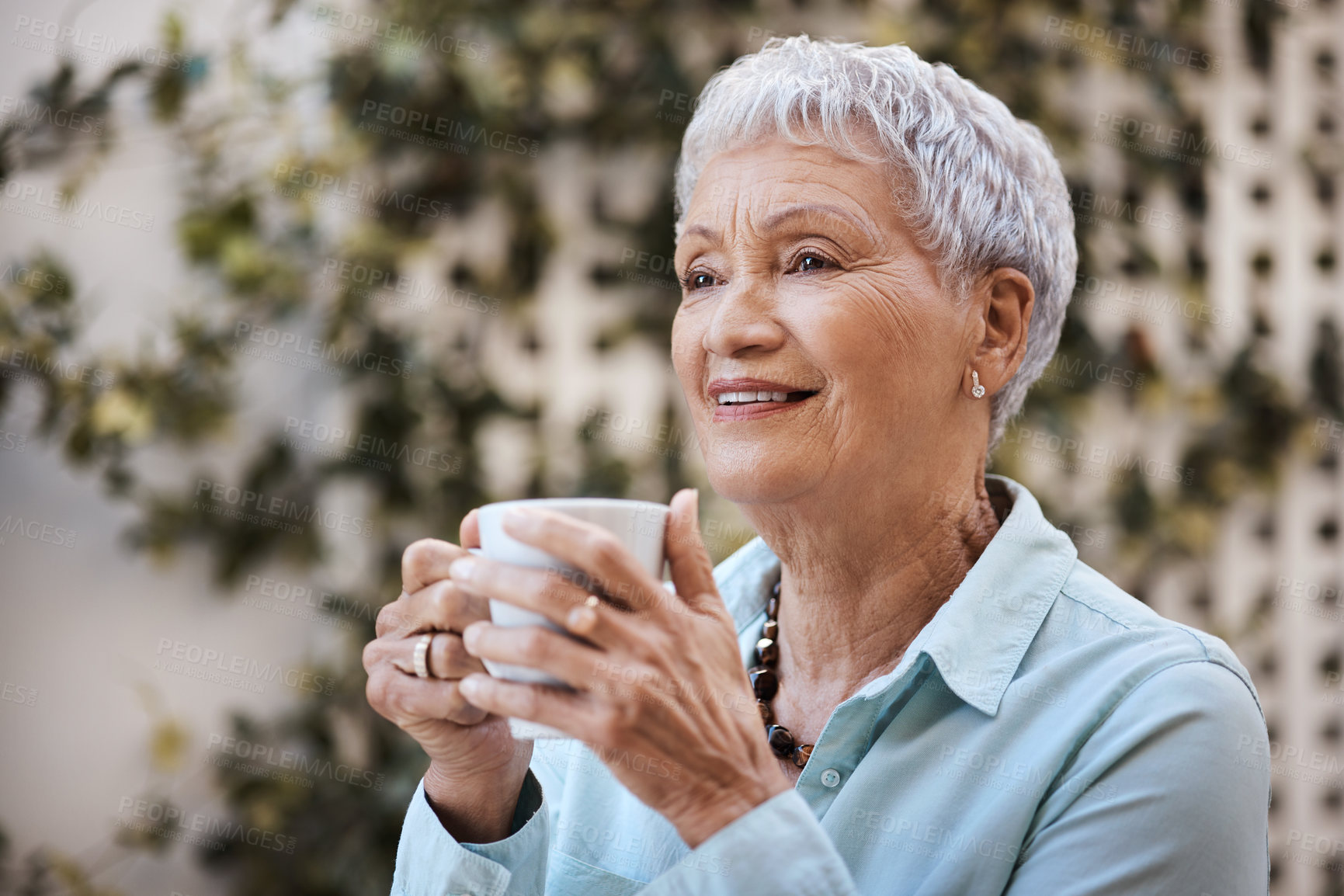 Buy stock photo Shot of a senior woman having coffee in the garden at home