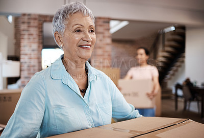 Buy stock photo Shot of a senior woman moving house with help from her daughter