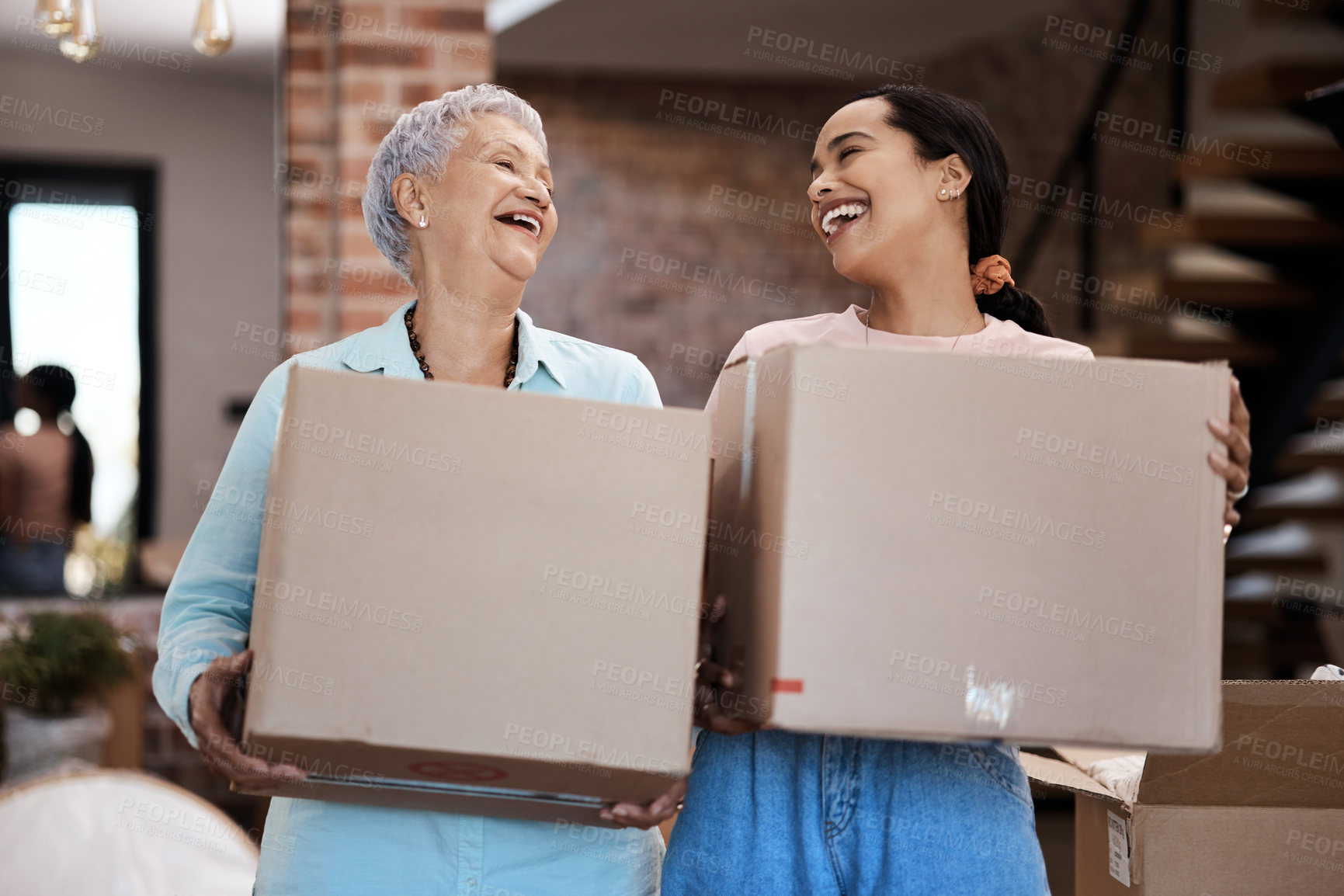 Buy stock photo Shot of a senior woman moving house with help from her daughter