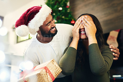 Buy stock photo Christmas surprise, gift and couple in home with husband and wife having fun and bonding on holiday. Xmas, love and woman with eyes closed receiving box of presents from man for festive celebration.