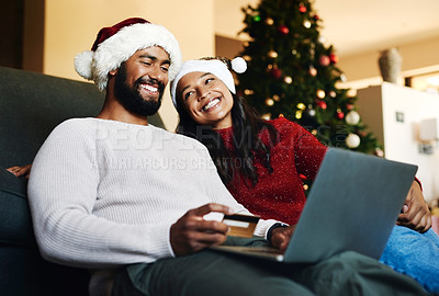 Buy stock photo Christmas, couple and couch with laptop, credit card and together for finance, festive season and ecommerce in lounge. Xmas, man and woman for payment, investments and online banking for transactions