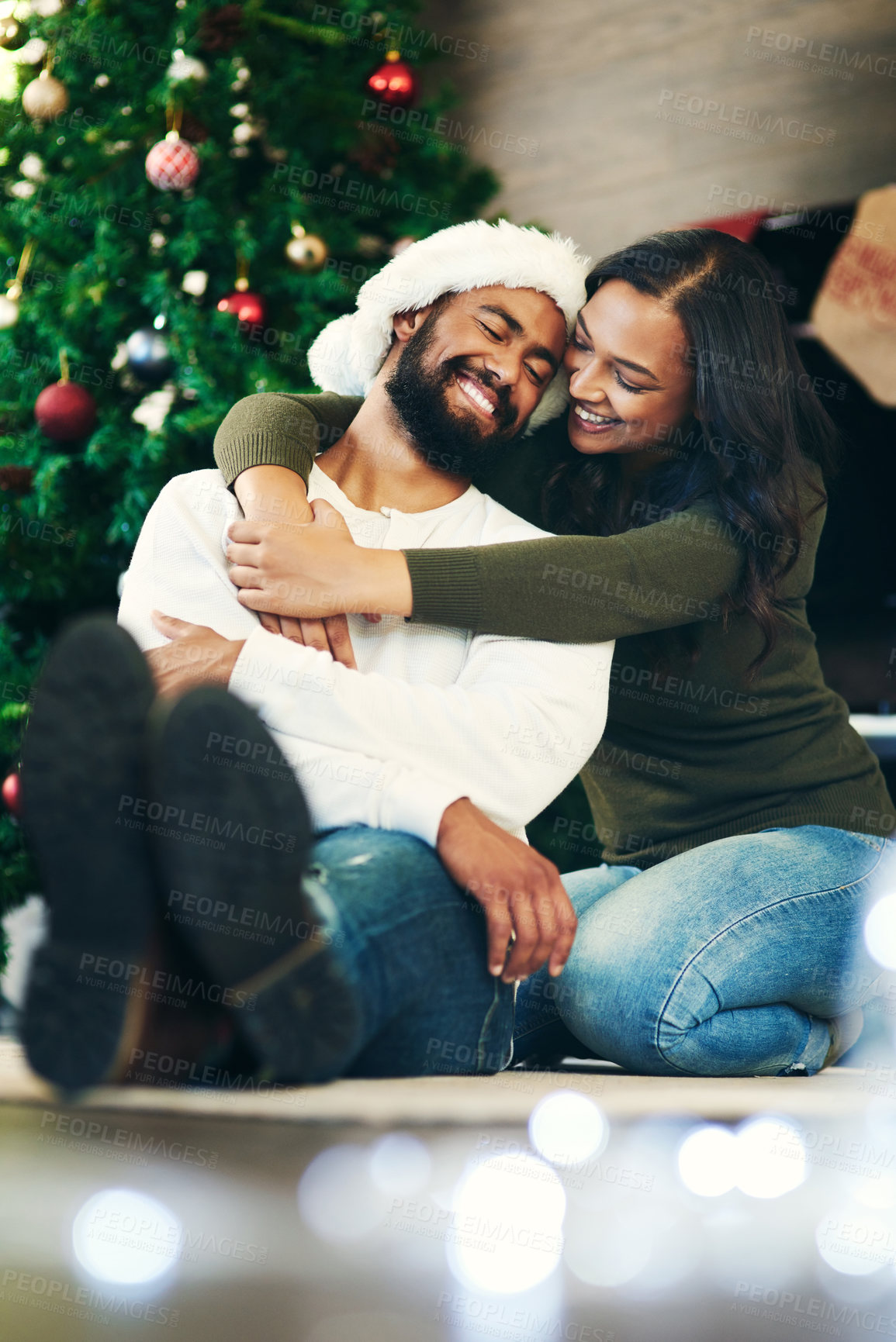 Buy stock photo Couple, love and bonding hug in christmas house or home living room in trust, festive support and love for Brazilian celebration holiday. Smile, happy or embrace woman and xmas man on apartment floor