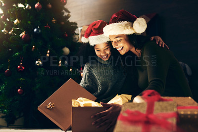 Buy stock photo Night, mother and child with a gift for Christmas in celebration of a happy family holiday in winter at home. Love, giving and exited mom opening a present box with girl kid to celebrate festive time