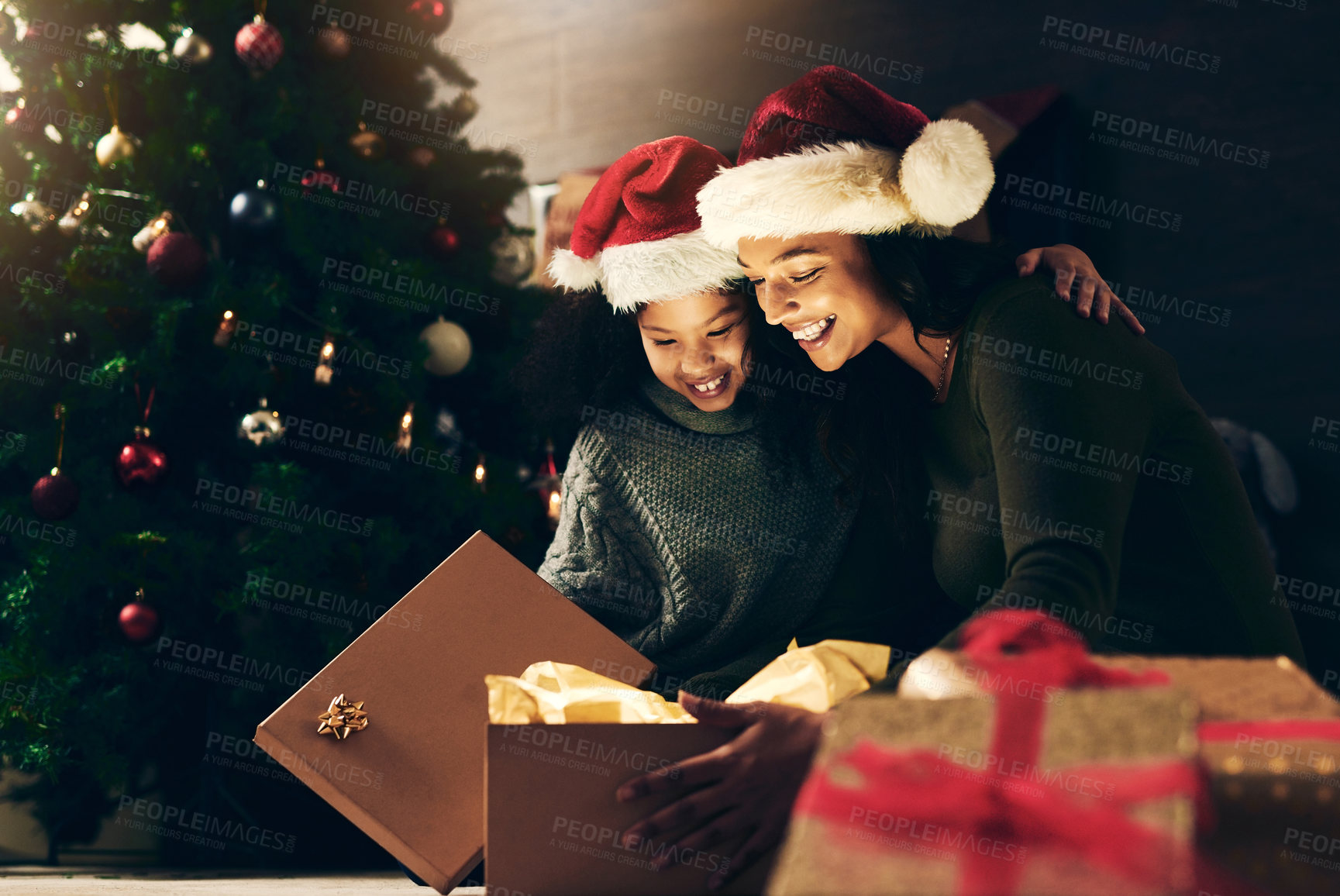 Buy stock photo Night, mother and child with a gift for Christmas in celebration of a happy family holiday in winter at home. Love, giving and exited mom opening a present box with girl kid to celebrate festive time