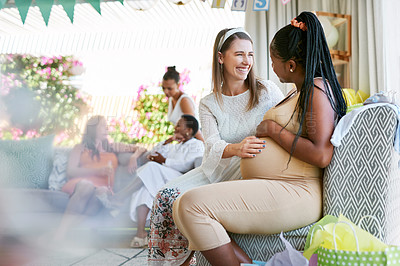 Buy stock photo Shot a woman touching her friends belly during her baby shower