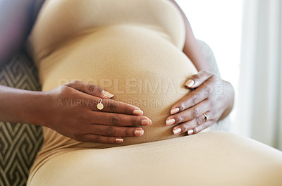 Buy stock photo Shot of a mother to be caressing her baby bump