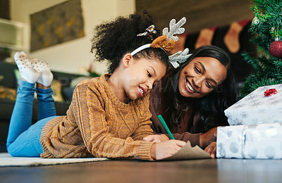 Buy stock photo Christmas, family and mother and girl writing letter to santa, relax and bond on living room floor. Love, child and mom help daughter with xmas wish list, happy and smile while enjoying conversation