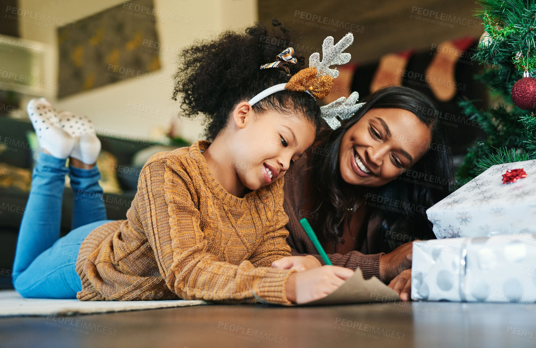 Buy stock photo Christmas, family and mother and girl writing letter to santa, relax and bond on living room floor. Love, child and mom help daughter with xmas wish list, happy and smile while enjoying conversation