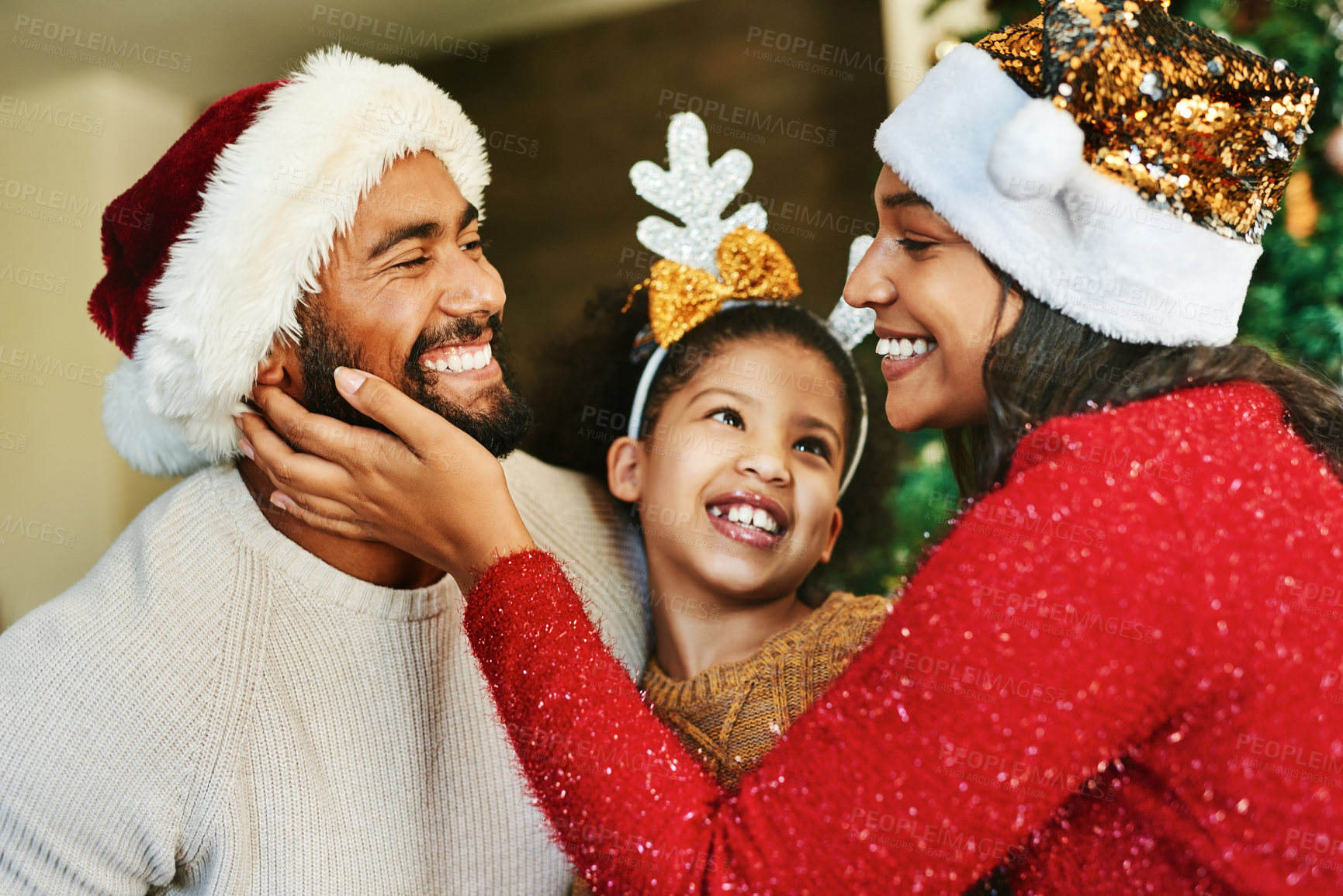 Buy stock photo Family, christmas celebration and love with happy smile and festive holiday, care. and decoration with hat in home. Mother, father and girl together in house to celebrate xmas event in family home