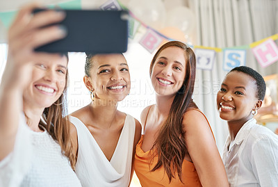 Buy stock photo Shot of a group of female friends taking selfies at a baby shower
