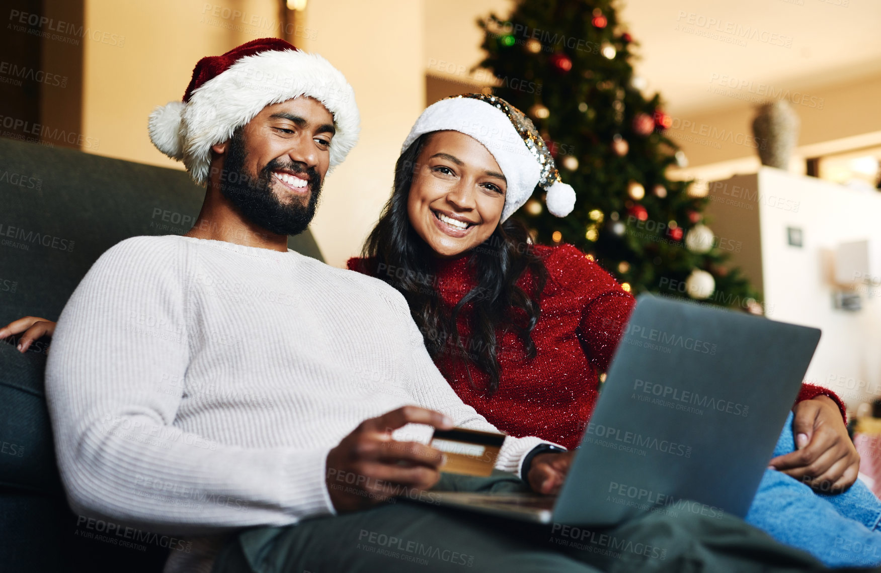 Buy stock photo Credit card, Christmas and black couple on laptop and sofa for home online shopping, easy e commerce payment and banking. Happy people on couch in living room with website sale on holiday finance app