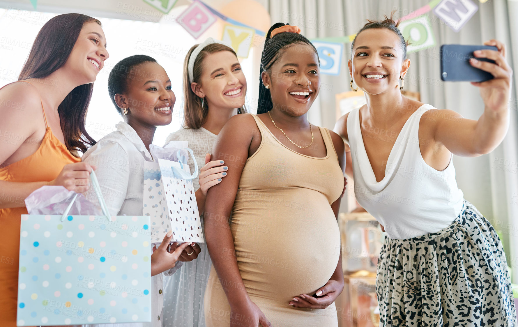 Buy stock photo Shot of a group of female friends taking selfies at a baby shower