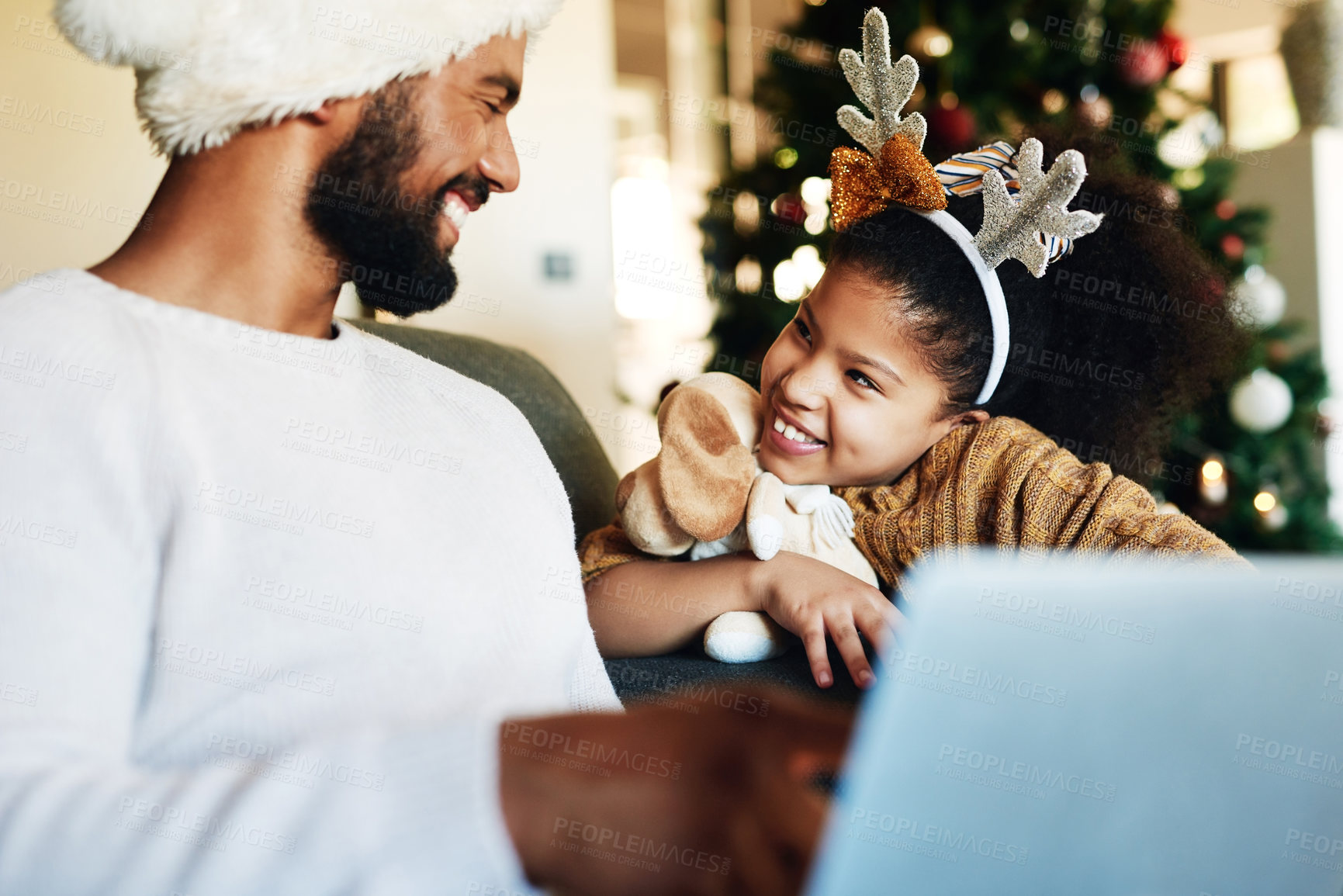 Buy stock photo Family, laptop and relax for christmas celebration on sofa in living room, girl and father together to celebrate holiday with xmas tree. Black family, happy and festive vacation or watch video online