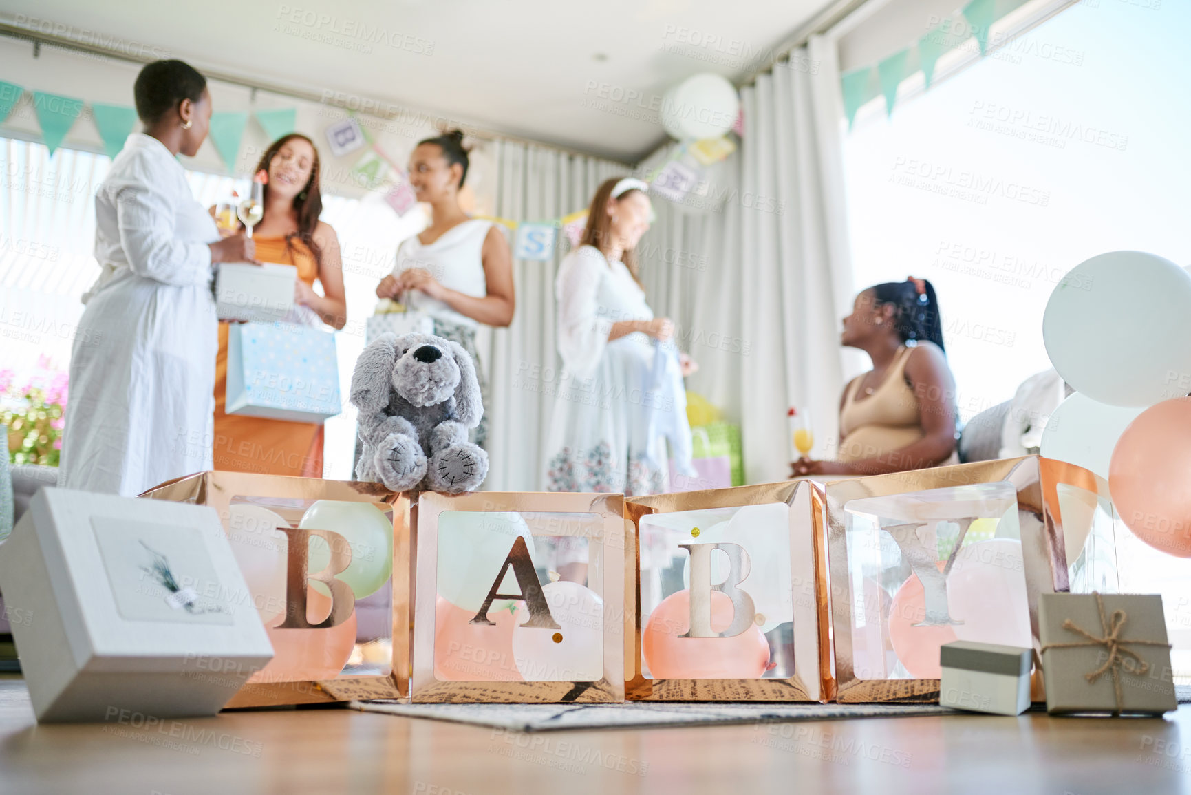 Buy stock photo Shot of a group of women holding a sign at a friends baby shower