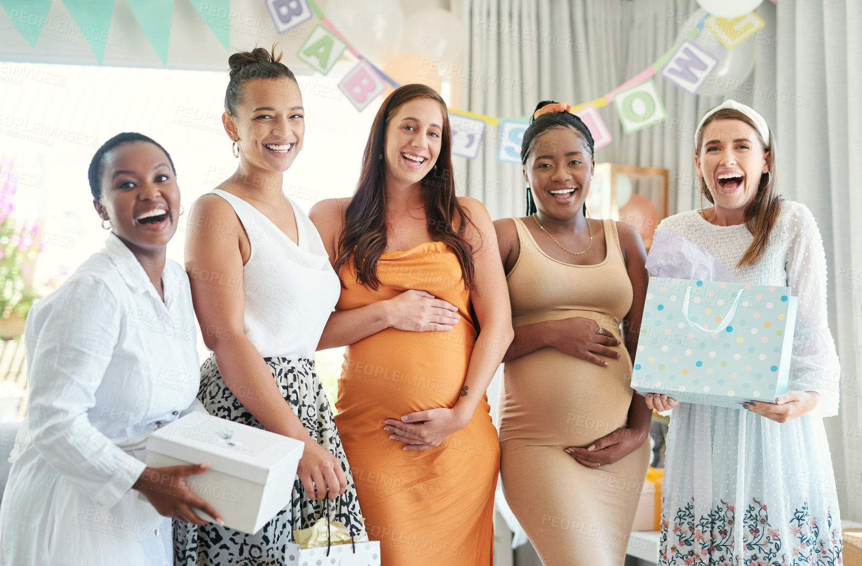 Buy stock photo Shot of a group of friends taking photos at a friends baby shower