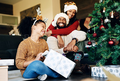 Buy stock photo Mother, father and girl with a Christmas gift hugging to celebrate love, happy family and winter holidays at home. Love, mom and excited dad in santa hat giving a young child or kid a surprise box 