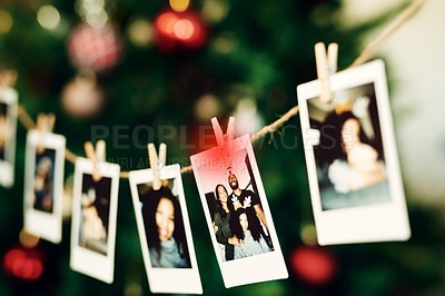 Buy stock photo Christmas, family and photo hanging for decoration on peg line for festival, tradition and vacation at home. Photography, holiday celebration and canvas pictures of people to decorate Christmas tree