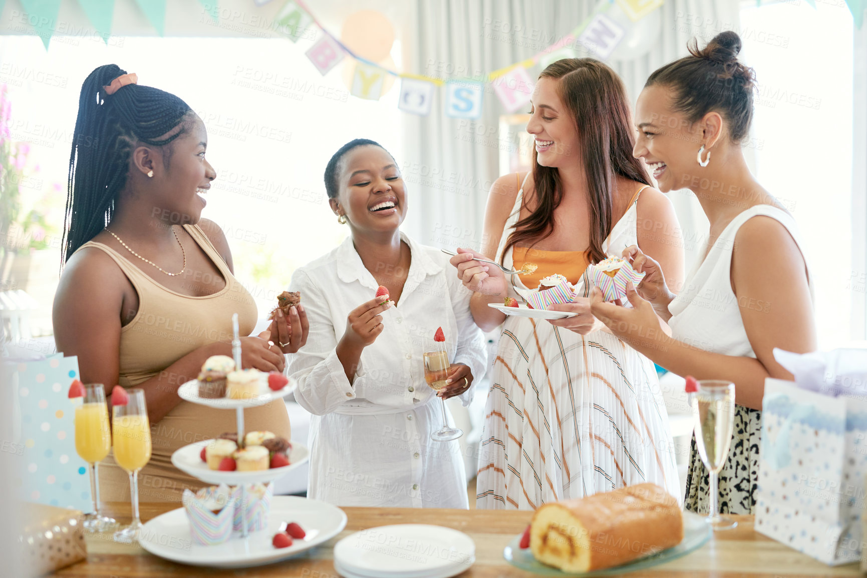 Buy stock photo Shot of a group of women eating dessert while celebrating at a friends baby shower