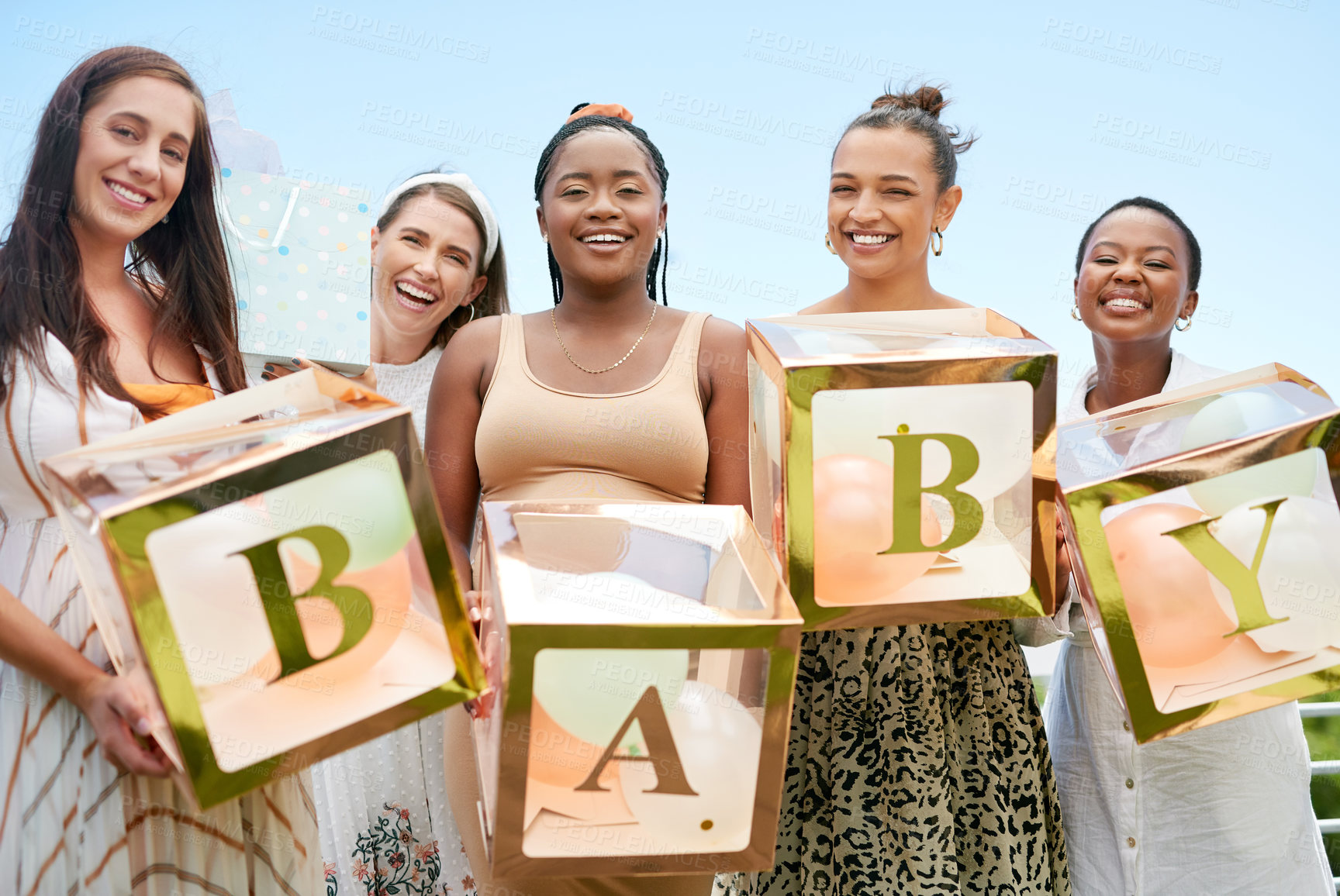Buy stock photo Shot of a group of women holding a sign at a friends baby shower