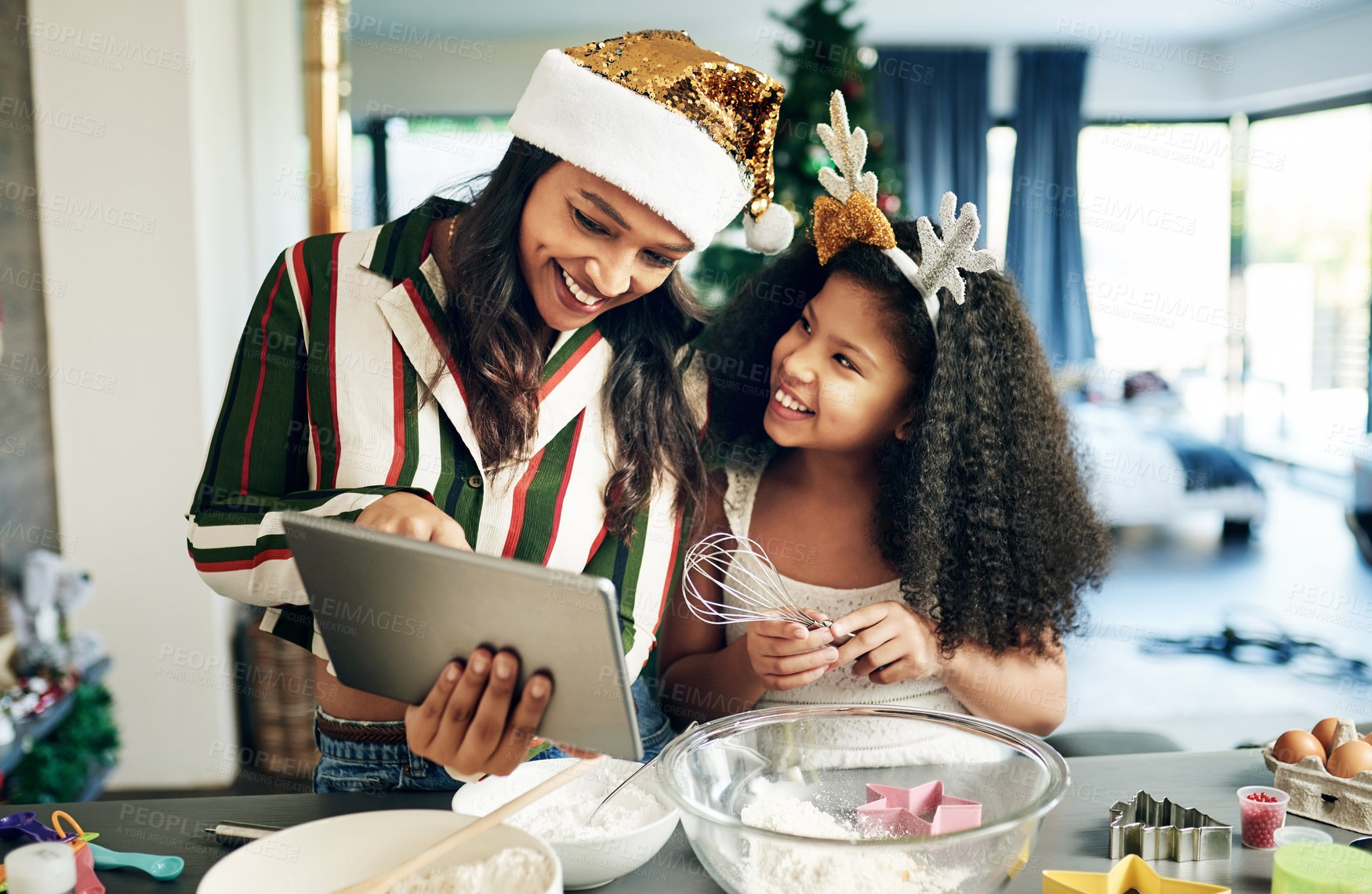 Buy stock photo Family, baking and tablet for christmas cookies, cooking or cake with mother and daughter together while learning online recipe in kitchen, Black woman and child making food to celebrate holiday