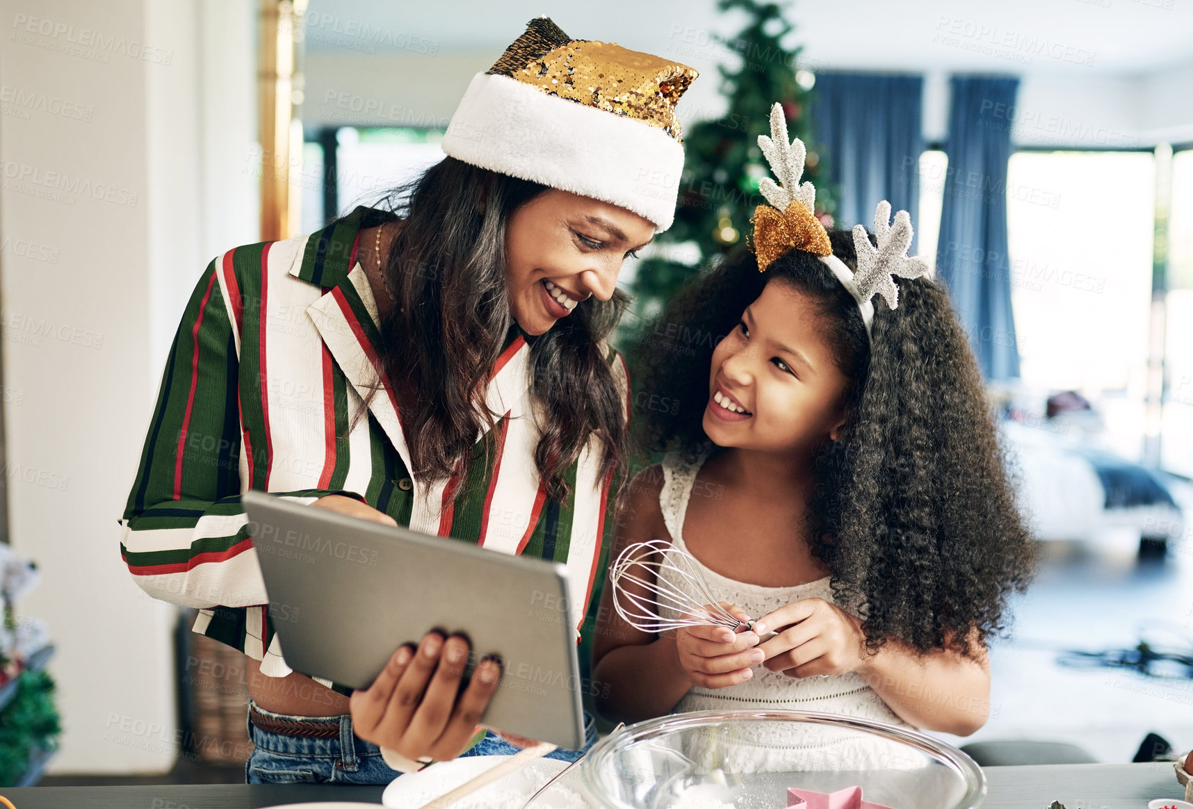 Buy stock photo Christmas, family and tablet for baking with mother and daughter together for cookies, cake or cooking for holiday celebration. Black woman and girl kid with technology for learning in home kitchen