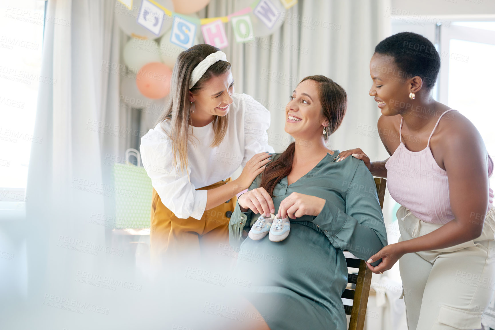 Buy stock photo Smile, pregnant woman and present with shoes for party, celebration and maternity group. Home, new mother and friends with love in living room with gift for baby shower, surprise or social event