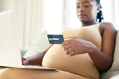Buy stock photo Shot of a young mother to be using her bank card to make online payments
