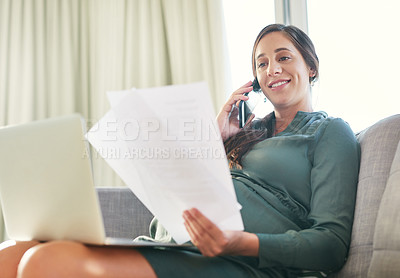 Buy stock photo Shot of a young mother to be working from home using her smartphone